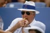 New York Yankees owner George Steinbrenner eating hot dog during spring training game, FL 3/20/1994 | Getty Images