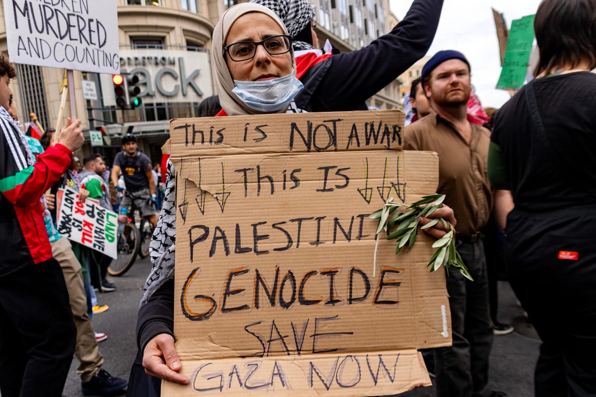 A protestor holds a sign accusing Israel of genocide. Image: Diane Krauthamer / Flickr 