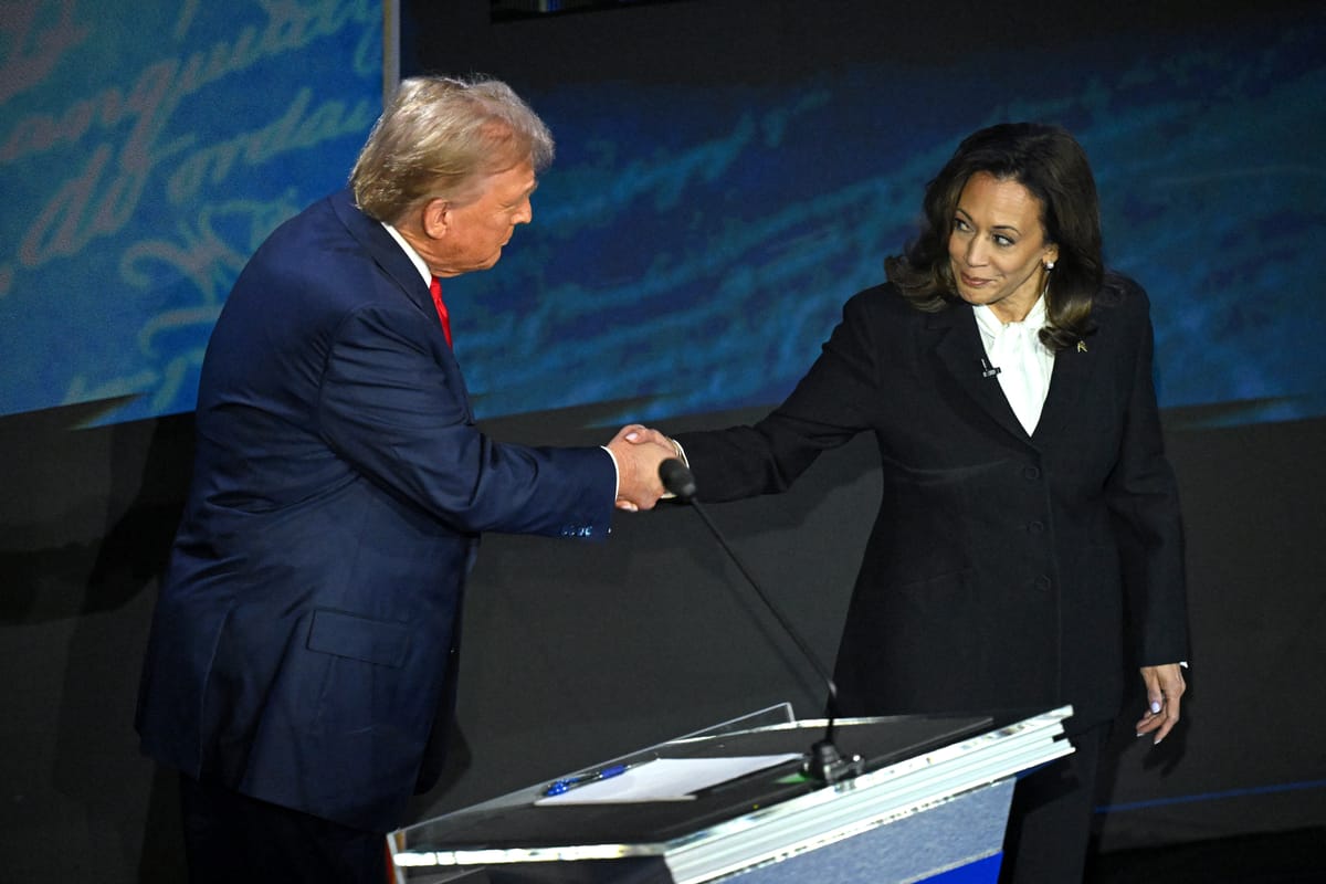 Trump and Harris shake hands before their first debate. Photo by SAUL LOEB / AFP