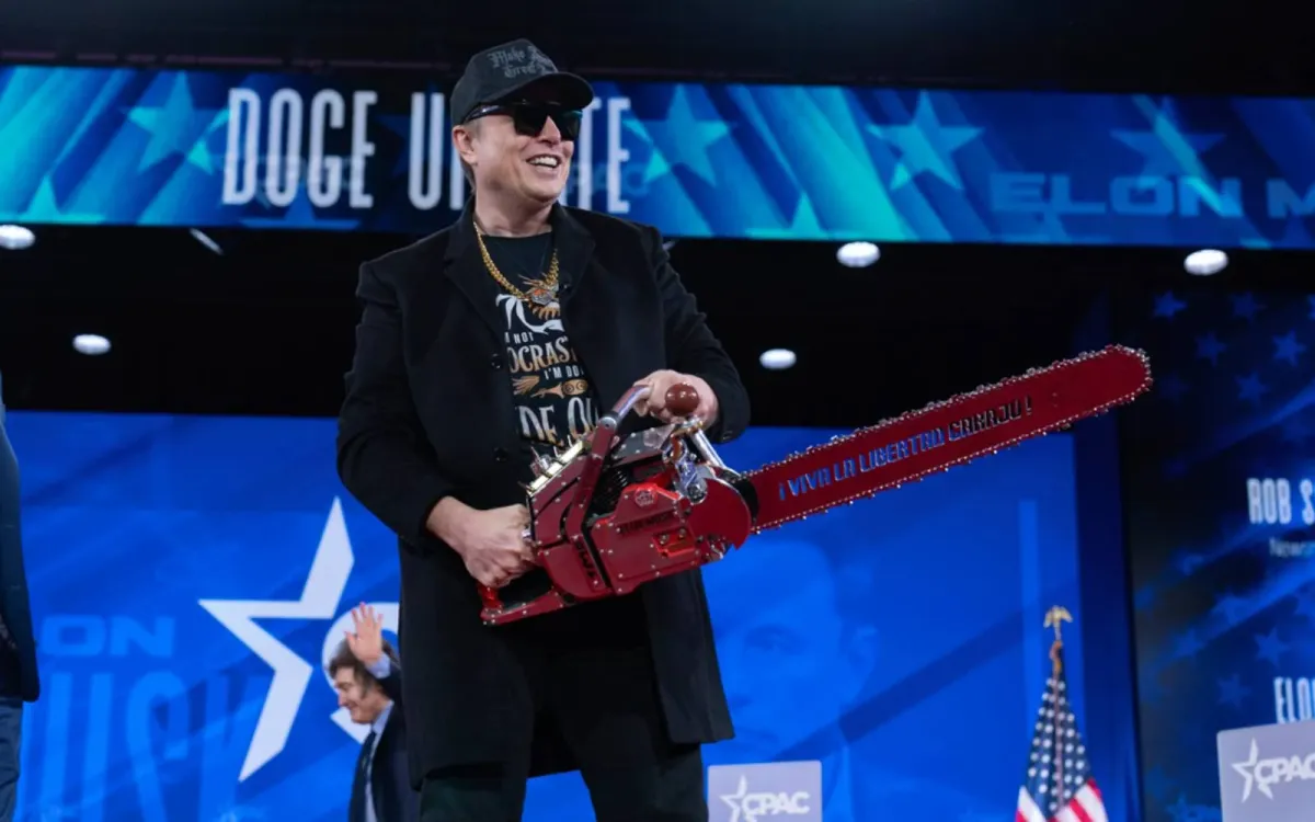 Elon Musk with a chainsaw at the Conservative Political Action Conference | The Associated Press