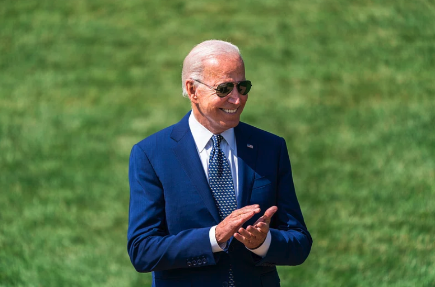 President Joe Biden claps during a clean car event in 2021. Image via White House / Flickr