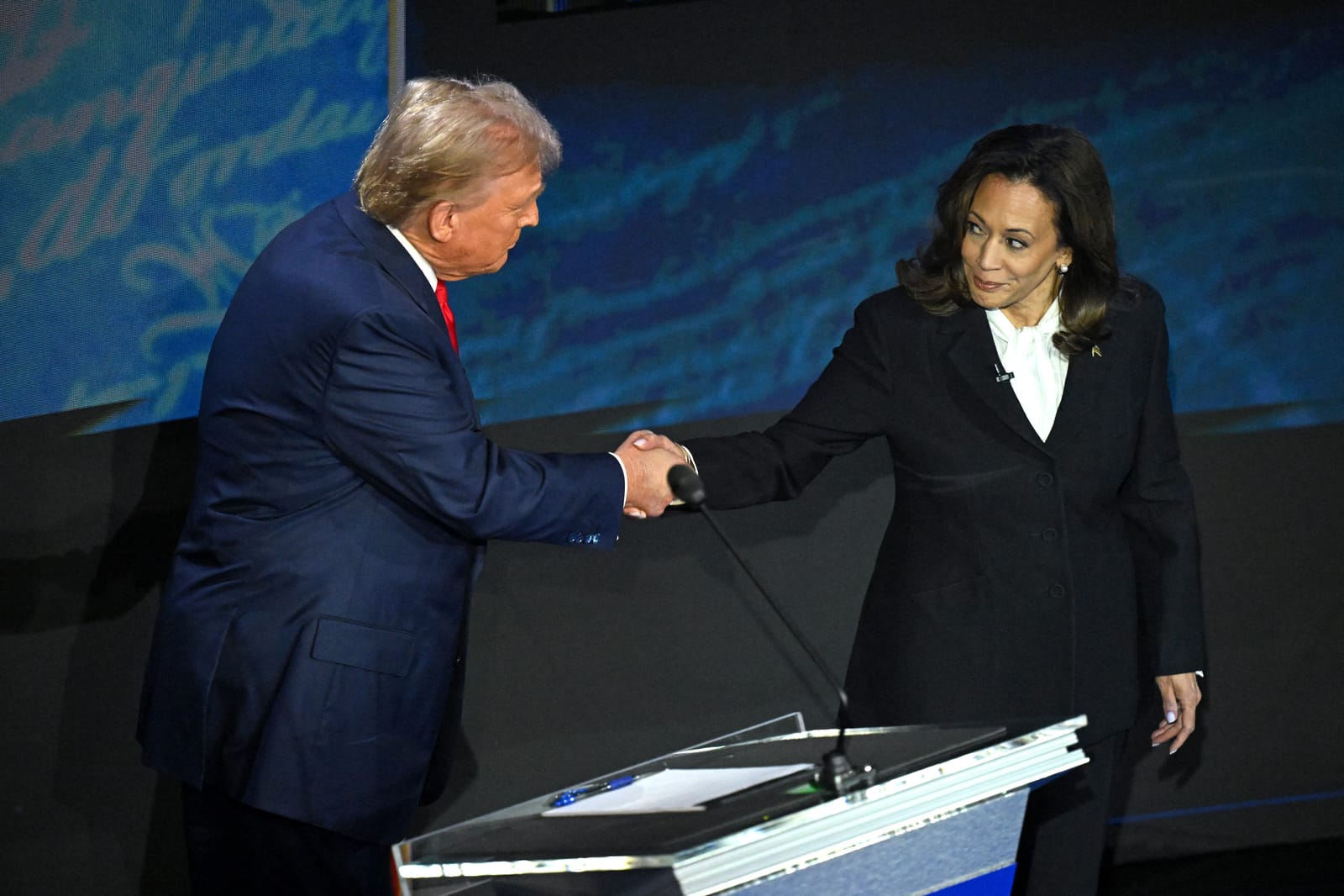 Trump and Harris shake hands before their first debate. Photo by SAUL LOEB / AFP