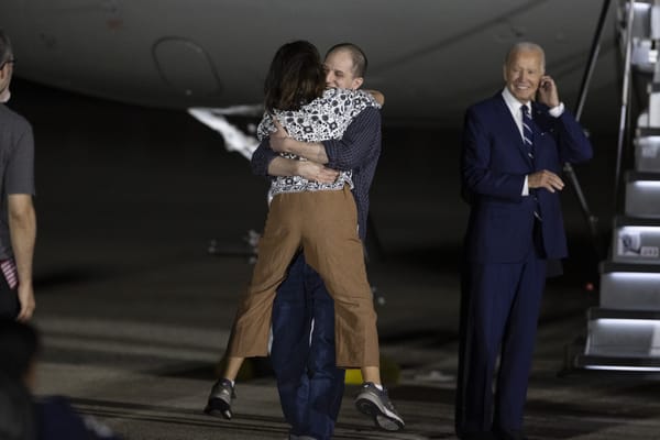 Evan Gershkovich embraces his mom after arriving in the U.S. (Mostafa Bassim/Getty Images)