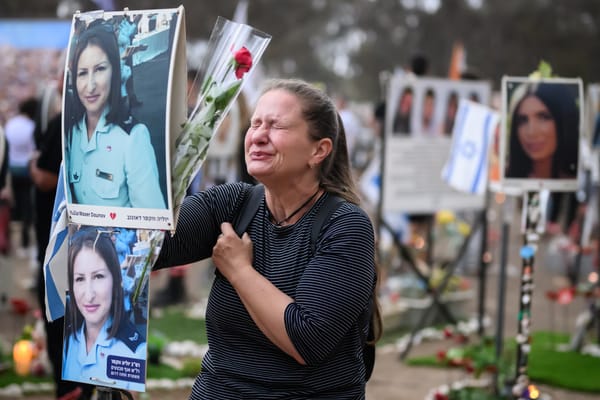 A woman breaks down at the memorial to Yulia Waxer Daunov. (Photo by Leon Neal/Getty Images)