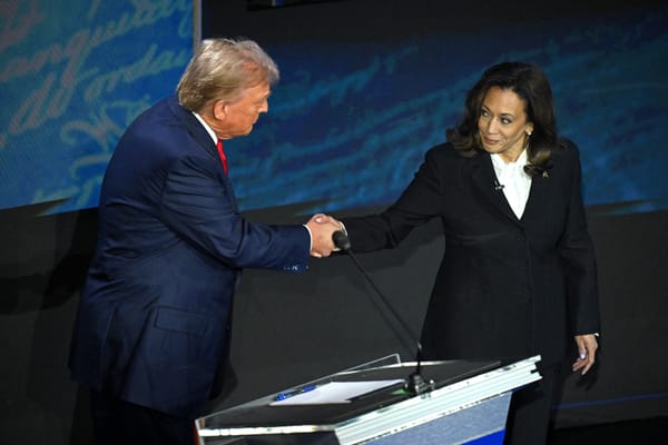 Trump and Harris shake hands before their first debate. Photo by SAUL LOEB / AFP